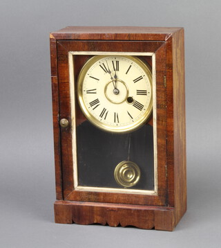An American mantel timepiece with paper dial and Roman numerals complete with pendulum and key 