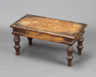 An Edwardian rectangular oak stool/occasional table raised on turned supports 28cm x 60cm w x 32cm d (water marks to the top) 