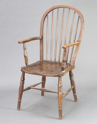 A beech and elm stick back Windsor style open armchair raised on turned supports with H framed stretcher 