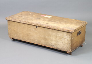 A 19th Century pine trunk with iron drop handles and hinged lid 42cm h x 125cm w x 54cm d (replacement hinges)