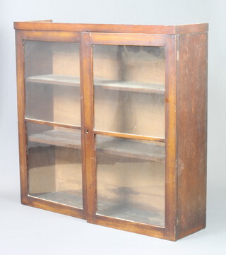 A 19th Century mahogany cabinet fitted shelves enclosed by a glazed panelled door 94cm h x 98cm w x 26cm d 
