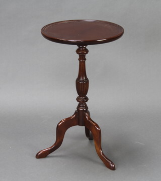 A Georgian style circular mahogany wine table raised on a pillar and tripod base 64cm h x 38cm diam. 