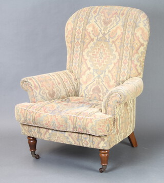 A Victorian style armchair upholstered in tapestry material 