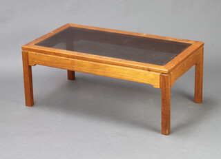 A mid Century rectangular teak coffee table with smoked plate glass top 37cm x 91cm x 51cm 