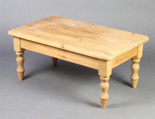 A rectangular pine coffee table on turned supports 45cm h x 92cm l x 57cm (ring marks, water damage and pitting to the top)  
