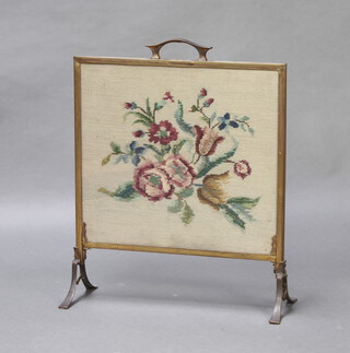 A gilt metal framed fire screen with Berlin woolwork panel to the centre 61cm x 49cm x 19cm 
