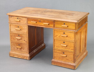 A 19th Century LCC pitched pine pedestal desk fitted 1 long and 8 short drawers 79cm h x 129cm w x 66cm d (split to the top) 