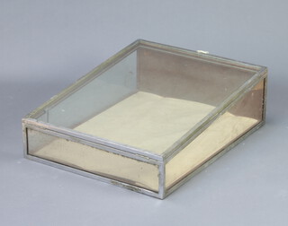 A chrome and plate glass wedge shaped table top display cabinet 23cm h x 57cm w x 74cm d