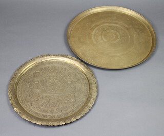 Two circular Eastern brass chargers 57cm and 50cm diam. 