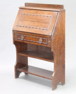 An oak students bureau with raised back fitted a fall front above a drawer and recess 110cm h x 75cm w x 27cm d 