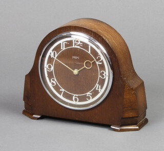 A Smiths 1950's mantel timepiece with Arabic numerals contained in an oak arch shaped case
