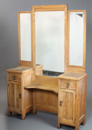 An Edwardian oak dressing table with triple mirror, recess flanked by a pair of cupboards and 1 drawer above a cupboard 174cm h x 120cm w x 33cm d (the handles are replacements) 