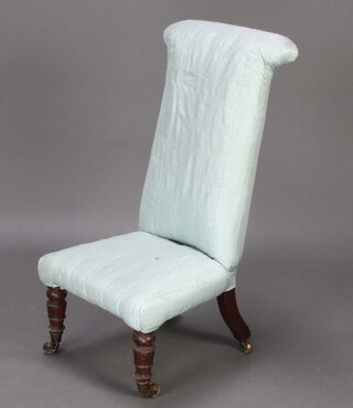 A Victorian prie dieu chair upholstered in blue material raised on castors (1 f)