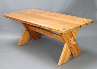 A pine refectory dining table, the top formed of 4 planks raised on X framed supports with H framed stretcher 75cm h x 182cm l x 91cm w 