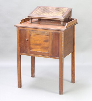 A Victorian rectangular beech and cane kneeling stool on bun feet 16cm x 46cm x 13cm, a 1920's mahogany wash stand with 3/4 gallery fitted cupboards 80cm h x 61cm w x 47cm d (some paint splashes to the top, aA circular brass twin handled preserving pan 11cm h x 22cm diam. and a pine and metal washboard 57cm h x 32cm w 