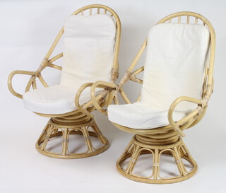 A pair of 1960's bamboo revolving chairs 