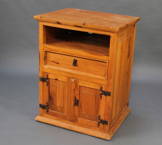 A pine cabinet with recess above drawer, base enclosed by panelled door, raised on a platform base 84cm x 64cm x 53cm and a pine bedside cabinet fitted a drawer enclosed by a panelled door 73cm h x 49cm w x 41cm d (a/f)