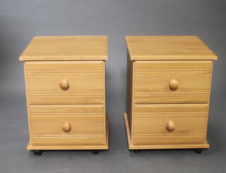 A pair of laminate finished bedside chests of 2 drawers 49cm h x 41.5cm x 41.5cm 