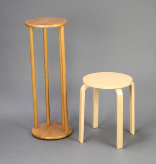 A 1970's circular plywood occasional table 45cm h x 35cm diam. and a mid Century teak circular jardiniere on turned supports 84cm h x 30cm diam.