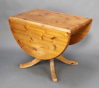A pine pedestal table raised on a pillar and tripod base 72cm h x 92cm w x 62cm d 