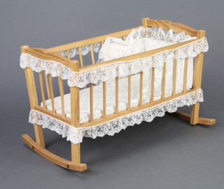 A child's pine rocking toy crib 36cm x 58cm x 37cm 
