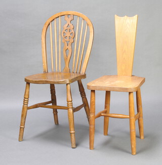 An elm wheel back chair together with an elm hall chair with solid seat and back, raised on turned and block supports 