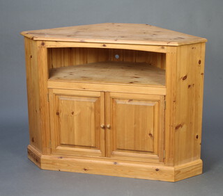 A pine corner cabinet with recess above cupboard on a platform base 90cm h x 118cm w x 65cm d