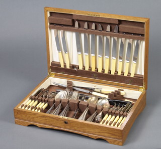 A part canteen of silver plated Old English pattern flatware contained in an oak canteen box 