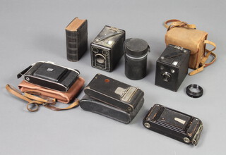 A 6-20 Brownie box camera, a ditto Junior, Kodak No2 folding autographic Brownie camera, a Coronet folding camera, Kodak Kodette 3 folding camera, a Prinz Galaxy 1:2.8 F=135mm lens no.80457 and a leather bound book of common prayer 
