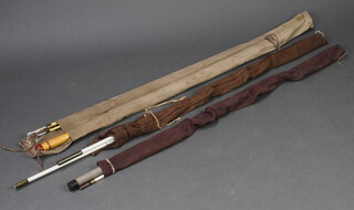 Three vintage sea fishing rods, all contained in cloth bags 