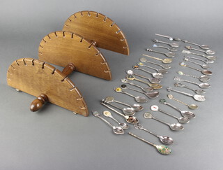 A collection of silver plated souvenir spoons and 3 tier demi lune display stand 