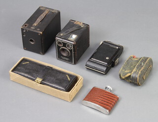 A Brownie C box camera, a No. Brownie box camera model D, a folding camera, pair of opera glasses, hip flask and a leather cased bridge/crib set 