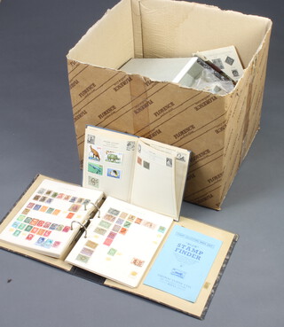 A large cardboard box containing an Improved album of world stamps, ring binder album and loose world stamps 