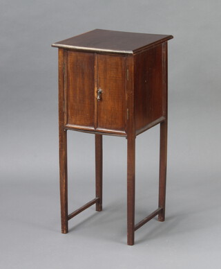 A mahogany cabinet fitted a drawer enclosed by panelled doors 72cm h x 33cm w x 34cm d 