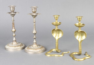 A pair of brass Cobra candlesticks 19cm and a pair of Benares brass candlesticks 23cm 
