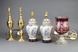 A pair of gilt metal table lamps 33cm, pair of table lamps in the form of lidded urns 27cm and a a cutler overlay glass table lamp 28cm (f) 