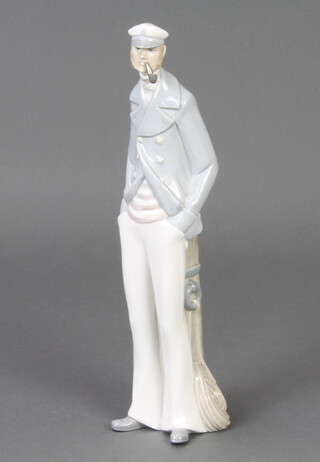 A Lladro figure of a standing sailor smoking a pipe 37cm 