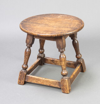 A circular oak occasional table raised on turned and block supports 43cm x 45cm diam. (sun bleached in places)