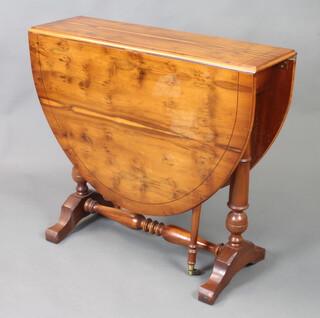 A Georgian style oval yew drop flap gateleg dining table 74cm x 83cm w x 28cm d 