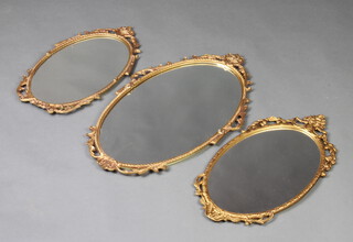 Three oval plate wall mirrors contained in decorative gilt frames 67cm x 39cm, 50cm x 27cm and 54cm x 27cm (3) 