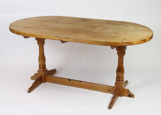 An oval pine refectory style dining table raised on turned columns and H framed stretcher 73cm h x 166cm l x 90cm w (felt tip, ring marks and slight water damage to the top)