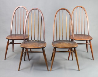 A set of 4 Ercol dark elm stick and hoop back dining chairs with turned supports and H framed stretcher 