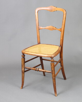 A Victorian mahogany ladder back bedroom chair with woven cane seat