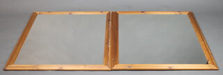 A pair of rectangular plate wall mirrors contained in decorative pine frames 112cm x 89 cm and 116cm x 90cm d 