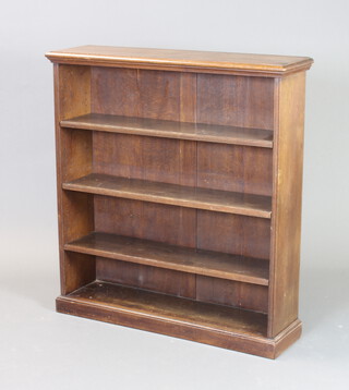 A 1920's oak bookcase fitted adjustable shelves raised on a platform base 109cm h x 101cm w x 28cm d 