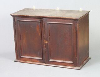 A 19th Century mahogany cabinet with moulded cornice enclosed by panelled doors 45cm h x 66cm w x 30cm d 