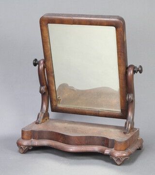 A Victorian rectangular bevelled plate dressing table mirror contained in mahogany swing frame, the base of serpentine outline, raised on bun feet 65cm h x 53cm w x 28cm d 