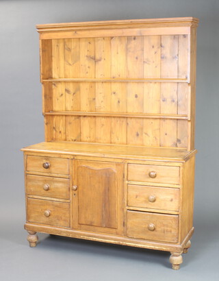 A Victorian pine dresser with raised back, the base fitted a cupboard enclosed by arch shaped panelled doors flanked by 6 short drawers with tore handles, raised on bun feet (some contact marks in places) 188cm h x 140cm w x 45cm d 