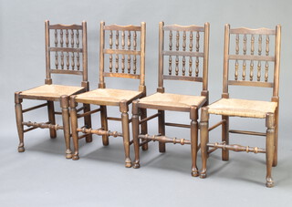 A set of 4 18th Century style elm spindle back dining chairs with woven cane seats
