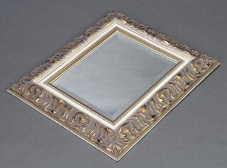 A rectangular bevelled plate wall mirror contained in a decorative gilt frame 55cm h x 47cm 